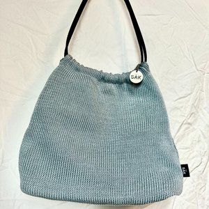 The Sak crocheted baby blue and navy bucket bag.